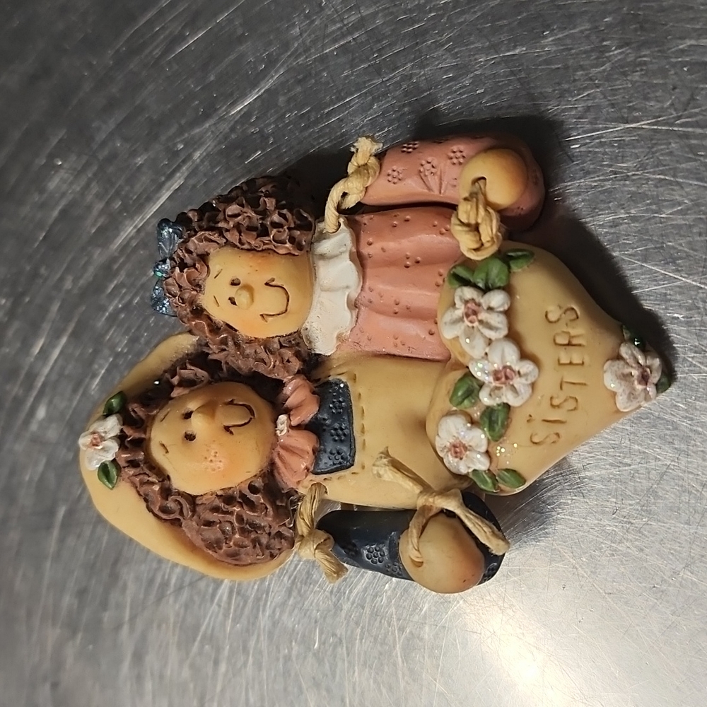 Sisters clay brooch holding a heart